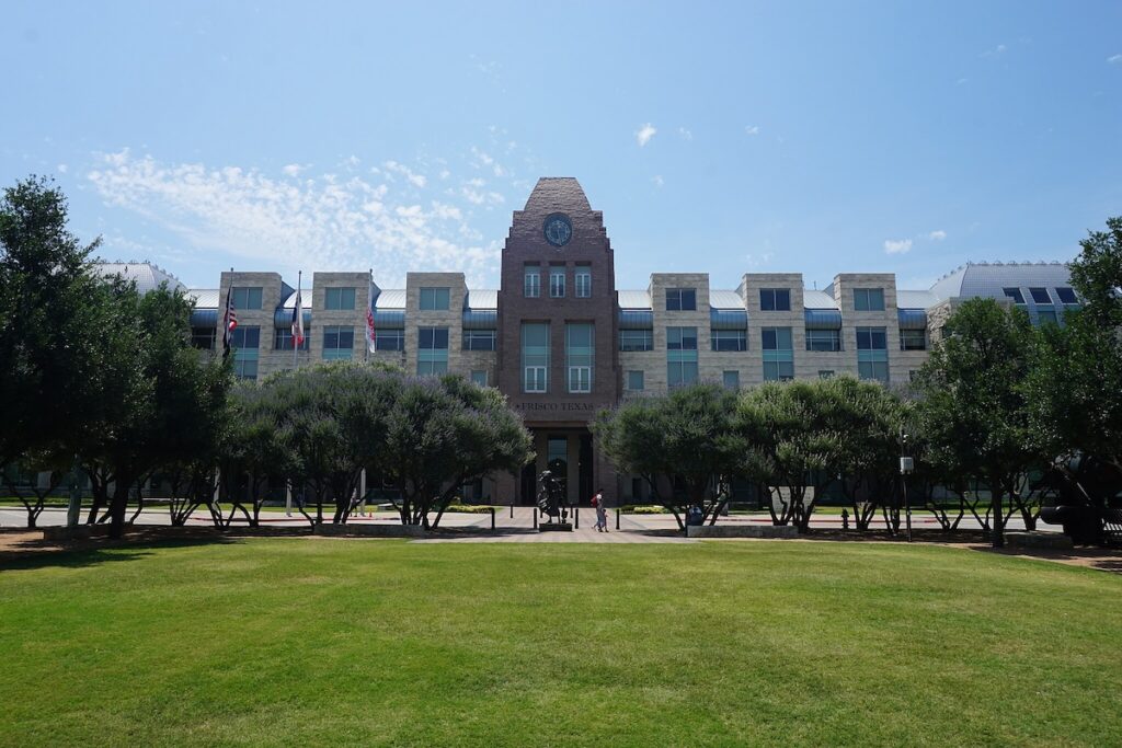 Frisco Texas square building with blue sky in the background